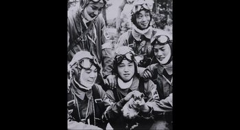 Movie still from “Aircraft Carrier: Guardian of the Seas” (2016), directed by Stephen Low – A black and white photo of a group of people wearing helmets and goggles; Medium shot, High angle