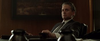 Movie still from “The Game” (1997), directed by David Fincher – A man sitting at a table with a keyboard; Close Up shot, Over the shoulder angle