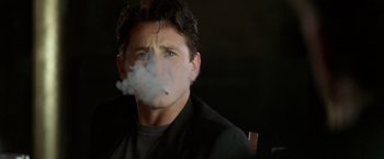 Movie still from “The Game” (1997), directed by David Fincher – A person smoking a cigarette; Close Up shot, Low angle