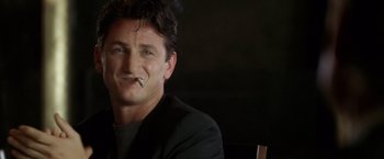 Movie still from “The Game” (1997), directed by David Fincher – A person sitting with a cigarette in his mouth; Close Up shot, Low angle