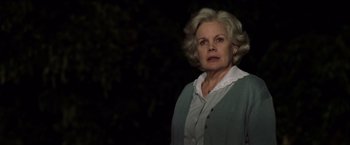 Movie still from “The Game” (1997), directed by David Fincher – An older woman in a white shirt and a green jacket; Close Up shot, Low angle