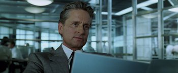 Movie still from “The Game” (1997), directed by David Fincher – A person wearing a suit and tie holding a computer; Close Up shot, Low angle