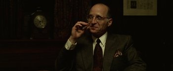 Movie still from “The Game” (1997), directed by David Fincher – An older man in a suit and tie talking on a cell phone; Close Up shot, Low angle