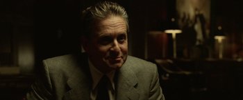 Movie still from “The Game” (1997), directed by David Fincher – A person wearing a suit and tie; Close Up shot, Over the shoulder angle