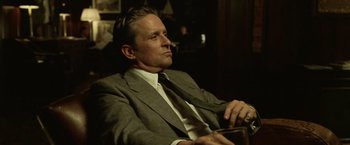 Movie still from “The Game” (1997), directed by David Fincher – A person wearing a suit and tie; Close Up shot, Low angle
