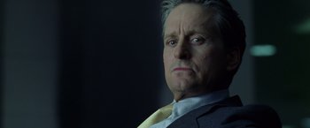 Movie still from “The Game” (1997), directed by David Fincher – An older man in a suit and tie looking at the camera; Close Up shot, Low angle