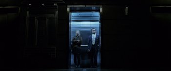 Movie still from “The Game” (1997), directed by David Fincher – A man and a woman standing in an elevator; Wide shot, Low angle