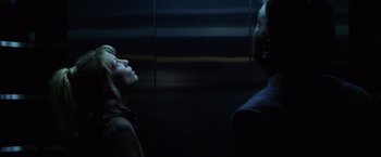 Movie still from “The Game” (1997), directed by David Fincher – A man and a woman in a dark room looking at each other; Close Up shot, Low angle