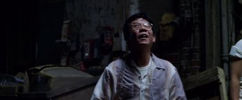 Movie still from “The Game” (1997), directed by David Fincher – An older man wearing glasses and a checkered shirt; Medium shot, Low angle