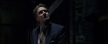 Movie still from “The Game” (1997), directed by David Fincher – A man in a suit and tie looking up; Close Up shot, Low angle