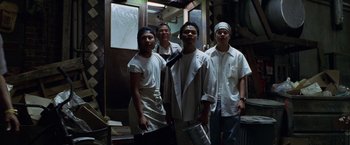 Movie still from “The Game” (1997), directed by David Fincher – A group of men standing next to each other in a room; Medium shot, Low angle
