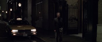 Movie still from “The Game” (1997), directed by David Fincher – A man walking down the street in the dark; Wide shot, Over the shoulder angle