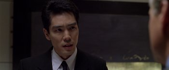 Movie still from “The Game” (1997), directed by David Fincher – A person wearing a suit and tie; Close Up shot, Low angle