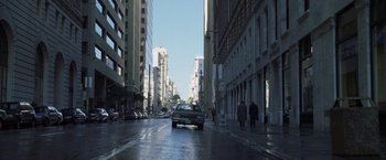 Movie still from “The Game” (1997), directed by David Fincher – A car driving down a street in the middle of a city; Extreme Wide shot, High angle