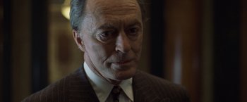 Movie still from “The Game” (1997), directed by David Fincher – An older man wearing a suit and tie; Close Up shot, Low angle