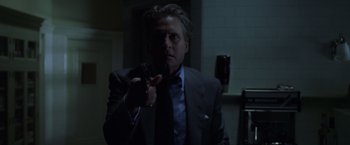 Movie still from “The Game” (1997), directed by David Fincher – A man in a suit and tie pointing at the camera; Close Up shot, Low angle