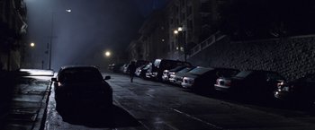 Movie still from “The Game” (1997), directed by David Fincher – Cars parked on the side of the road at night; Extreme Wide shot, High angle