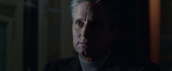 Movie still from “The Game” (1997), directed by David Fincher – An older man in a dark room looking at the camera; Close Up shot, Low angle