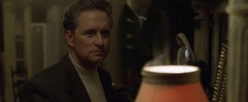 Movie still from “The Game” (1997), directed by David Fincher – A person near a lamp; Close Up shot, Over the shoulder angle