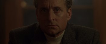 Movie still from “The Game” (1997), directed by David Fincher – An older man in a white shirt and a brown jacket; Close Up shot, Low angle