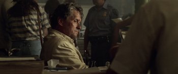 Movie still from “The Game” (1997), directed by David Fincher – A man sitting at a dinner table with his head resting on a plate; Close Up shot, Over the shoulder angle