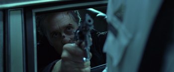 Movie still from “The Game” (1997), directed by David Fincher – A man holding a gun in front of a mirror; Close Up shot, Low angle