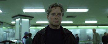 Movie still from “The Game” (1997), directed by David Fincher – A person wearing a black jacket; Close Up shot, Low angle