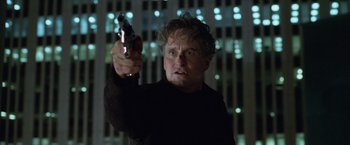 Movie still from “The Game” (1997), directed by David Fincher – A man holding a gun in his right hand; Close Up shot, Low angle
