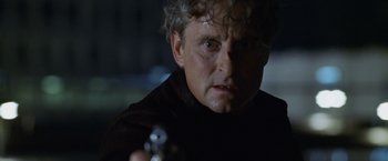 Movie still from “The Game” (1997), directed by David Fincher – A person holding a gun; Close Up shot, Over the shoulder angle