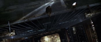 Movie still from “The Game” (1997), directed by David Fincher – A man standing on top of a metal structure; Wide shot, Overhead angle