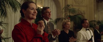 Movie still from “The Game” (1997), directed by David Fincher – A group of people standing next to each other clapping; Medium shot, Low angle