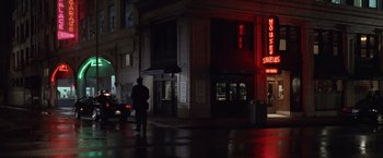Movie still from “The Game” (1997), directed by David Fincher – A man standing on the side of the street at night; Extreme Wide shot, Low angle