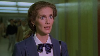 Movie still from “Airplane!” (1980), directed by David Zucker – A person wearing a suit and bow tie; Close Up shot, Over the shoulder angle