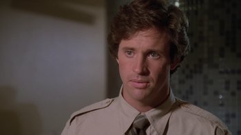 Movie still from “Airplane!” (1980), directed by David Zucker – A person wearing a shirt and a tie; Close Up shot, Over the shoulder angle