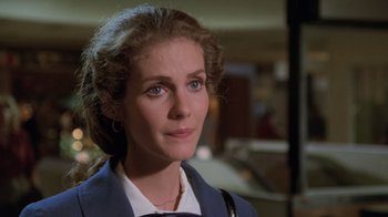 Movie still from “Airplane!” (1980), directed by David Zucker – A person wearing a suit and tie; Close Up shot, Over the shoulder angle