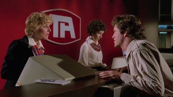 Movie still from “Airplane!” (1980), directed by David Zucker – A man and two women sitting in front of a counter; Medium shot, Low angle