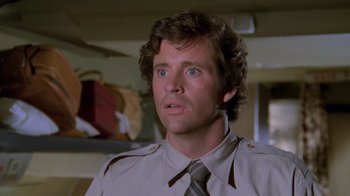 Movie still from “Airplane!” (1980), directed by David Zucker – A person wearing a shirt and a tie; Close Up shot, Low angle
