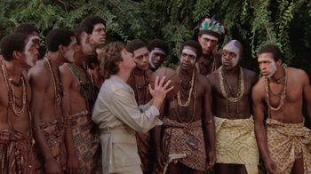 Movie still from “Airplane!” (1980), directed by David Zucker – A group of men standing next to each other; Medium shot, High angle