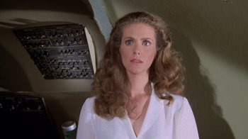 Movie still from “Airplane!” (1980), directed by David Zucker – A woman in a white shirt with long brown hair; Close Up shot, Low angle