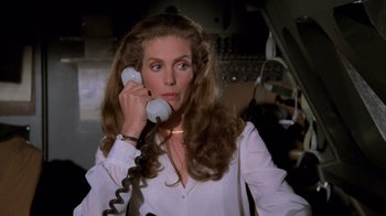 Movie still from “Airplane!” (1980), directed by David Zucker – A woman holding a phone up to her ear; Close Up shot, High angle