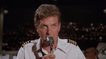 Movie still from “Airplane!” (1980), directed by David Zucker – A person wearing a pilot's uniform; Close Up shot, Low angle
