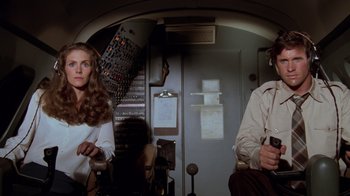 Movie still from “Airplane!” (1980), directed by David Zucker – A woman and a man sitting in a room; Medium shot, Low angle