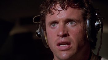 Movie still from “Airplane!” (1980), directed by David Zucker – A person wearing headphones; Close Up shot, Low angle