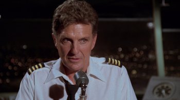 Movie still from “Airplane!” (1980), directed by David Zucker – A person wearing a pilot's uniform; Close Up shot, Low angle
