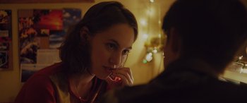 Movie still from “Alex Strangelove” (2018), directed by Craig Johnson – A woman sitting in front of a man in a room; Close Up shot, Over the shoulder angle