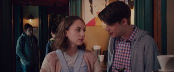 Movie still from “Alex Strangelove” (2018), directed by Craig Johnson – A man and a woman standing next to each other; Close Up shot, Over the shoulder angle