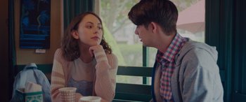 Movie still from “Alex Strangelove” (2018), directed by Craig Johnson – A man and a woman sitting in front of each other; Medium shot, Over the shoulder angle