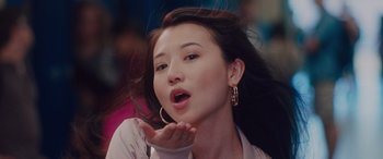 Movie still from “Alex Strangelove” (2018), directed by Craig Johnson – A beautiful young lady blowing a kiss at the camera; Close Up shot, Low angle