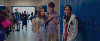 Movie still from “Alex Strangelove” (2018), directed by Craig Johnson – A group of young people standing in a school hallway; Medium shot, Over the shoulder angle
