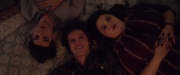 Movie still from “Alex Strangelove” (2018), directed by Craig Johnson – A man and a woman laying on a bed; Medium shot, Overhead angle